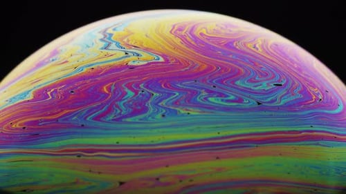 Colorful Hues Moving Downward in a Swirling Motion on Soap's Surface