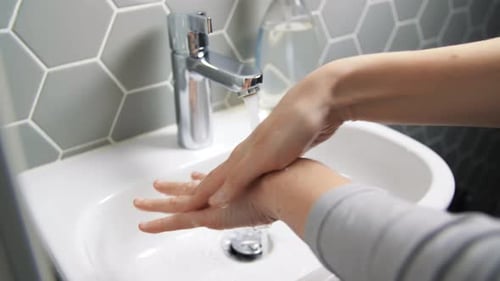 Close Up of Woman Washing Hands with Liquid Soap