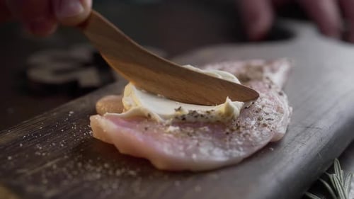 Chef Spreads Cream Cheese Over the Raw Chicken Breast Before Roasting, Close Up Shot of Cooking Meat