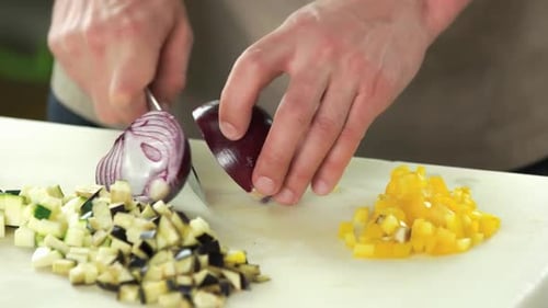 Hands Cutting Purple Onion