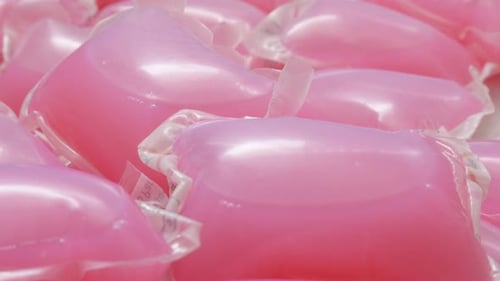 Lundry capsule pile modern pods close-up 4K 2160p 30fps UHD tilting footage - Slow tilt over liquid