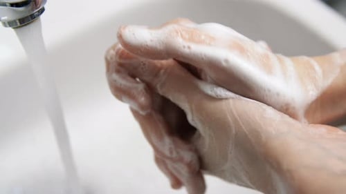 Close Up of Woman Washing Hands with Soap Foam