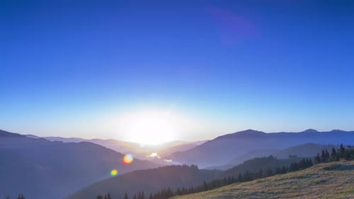 Sunrise in the Cloudless Sky over the Mountains