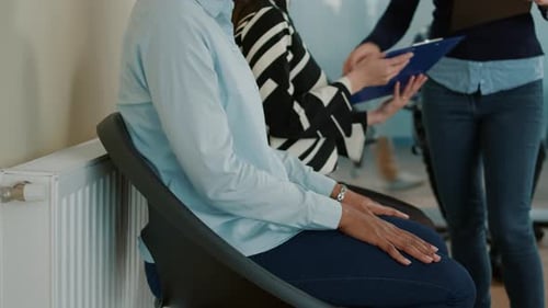 Female Applicant Looking at Cv Files and Waiting to Attend Hiring Meeting