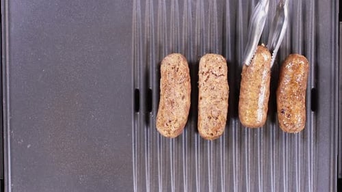 Turning Sausages On Grill