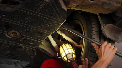 Close Up Shot of Car Suspension Service in Maintenance Car Garage