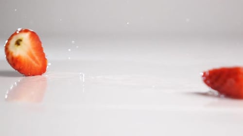 Sliced Strawberry Tumble on White Surface