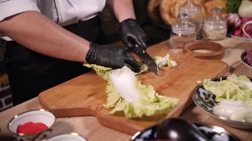 cutting vegetables lettuce, cook hands and knife