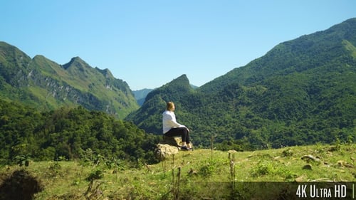 4K Woman Walking on Top of a Mountain Range to Enjoy Beautiful View