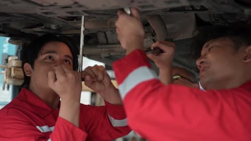 technician man car mechanic working in automotive garage to fix repair suspension auto car