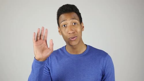 African Man Waving Hand to Say Hello White Background