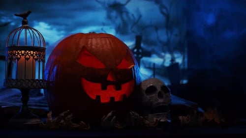 Scary laughing pumpkin and an old skull over the frightening gothic background.