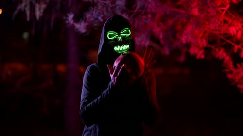 Death with Pumpkin in Hands Halloween Night Person in Suit with Glowing Skull Mask