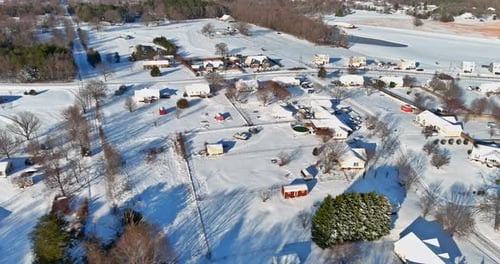 Aerial view a suburb after a fresh snow fall is shining brightly all roofs