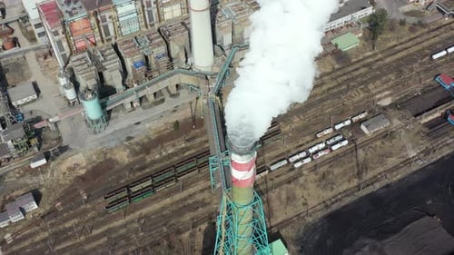 Birdseye aerial view, smoke and toxic vapors from coal power plant chimney, air pollution from indus