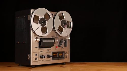 Taperecorder playing music isolated on black background and space for copy