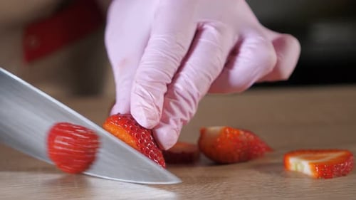 Chef Cook Cuts Strawberries on a Cutting Board