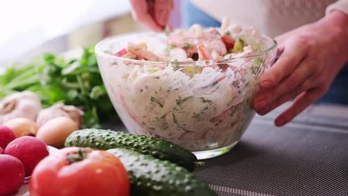 Closeup of Woman Slicing Dill on Wooden Cutting Board Preparing Ingredient for Meal