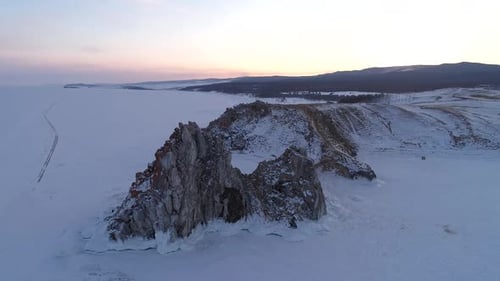 Aerial Orbital Shot of a Shamanka Rock on Olkhon Island at Sunset