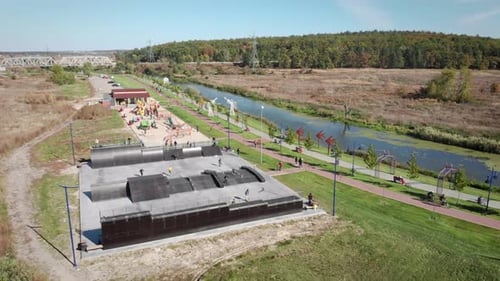 Aerial shot of Skate park. Skateboarder skateboarding in outdoor skate park.