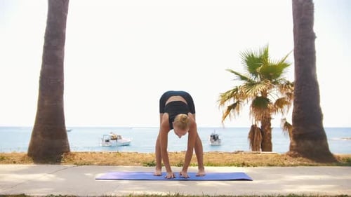 Gymnastics By the Sea a Blonde Woman Warms Up Her Body