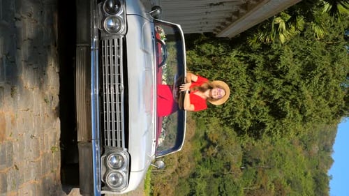 Vertical Video of Young Happy Stylish Smiling Woman or Girl is Standing in Vintage Car Enjoy Summer