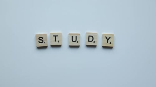 Hand Making Phrase Study Online with Wooden Letters on White Background