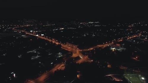 Aerial view of the streets of the city at night with Roundabout road junction 08