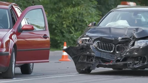 Damaged in Heavy Car Accident Vehicles After Collision on City Street Crash Site