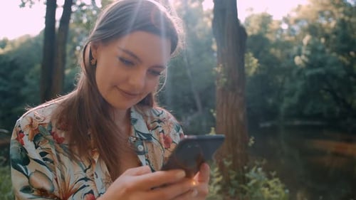 Young girl navigate in internet on her smartphone