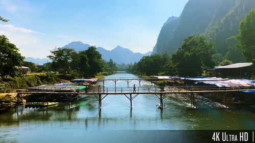 4K People Walking Across a Bamboo Bridge in the Mountainous Countryside of Vang Vieng, Laos