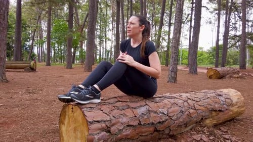 Blonde woman suffering with knee pain, injury, fracture