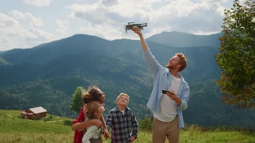 Happy Family Using Drone on Walk Mountains