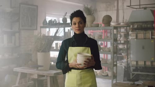 Woman Is Holding Clay Pots In Workshop
