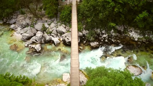 Aerial view of a wooden bridge with water going underneath at Soca River.
