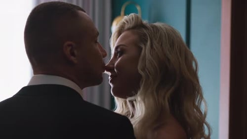 Bridegroom Kisses Nose of Beloved Woman in Hotel Room