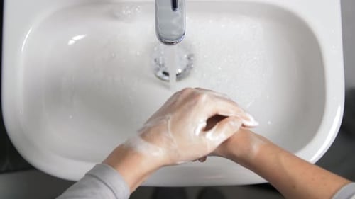 Close Up of Woman Washing Hands with Soap Foam