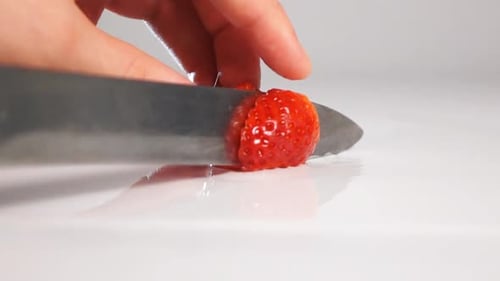 Cut Strawberry on White Surface By Knife