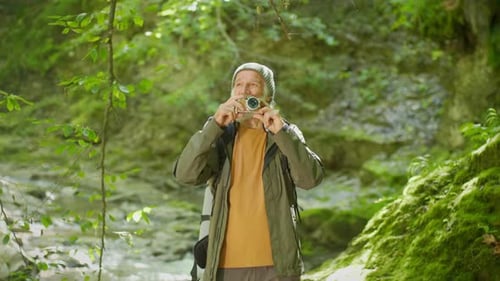 Happy Old Male Tourist with a Digital Camera Photographing Nature Scenery