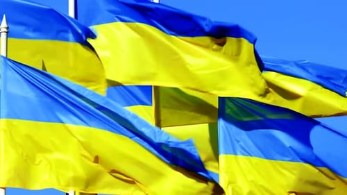 Stacked Ukrainian Flags Flutter on Wind Over Blue Sky